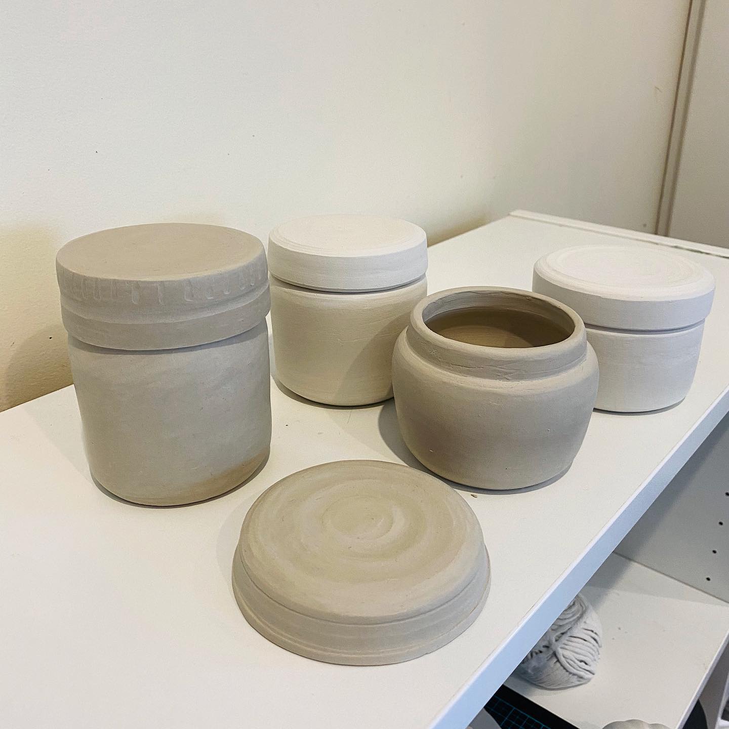 Lidded ceramic vessels in progress by Leaf Ceramics